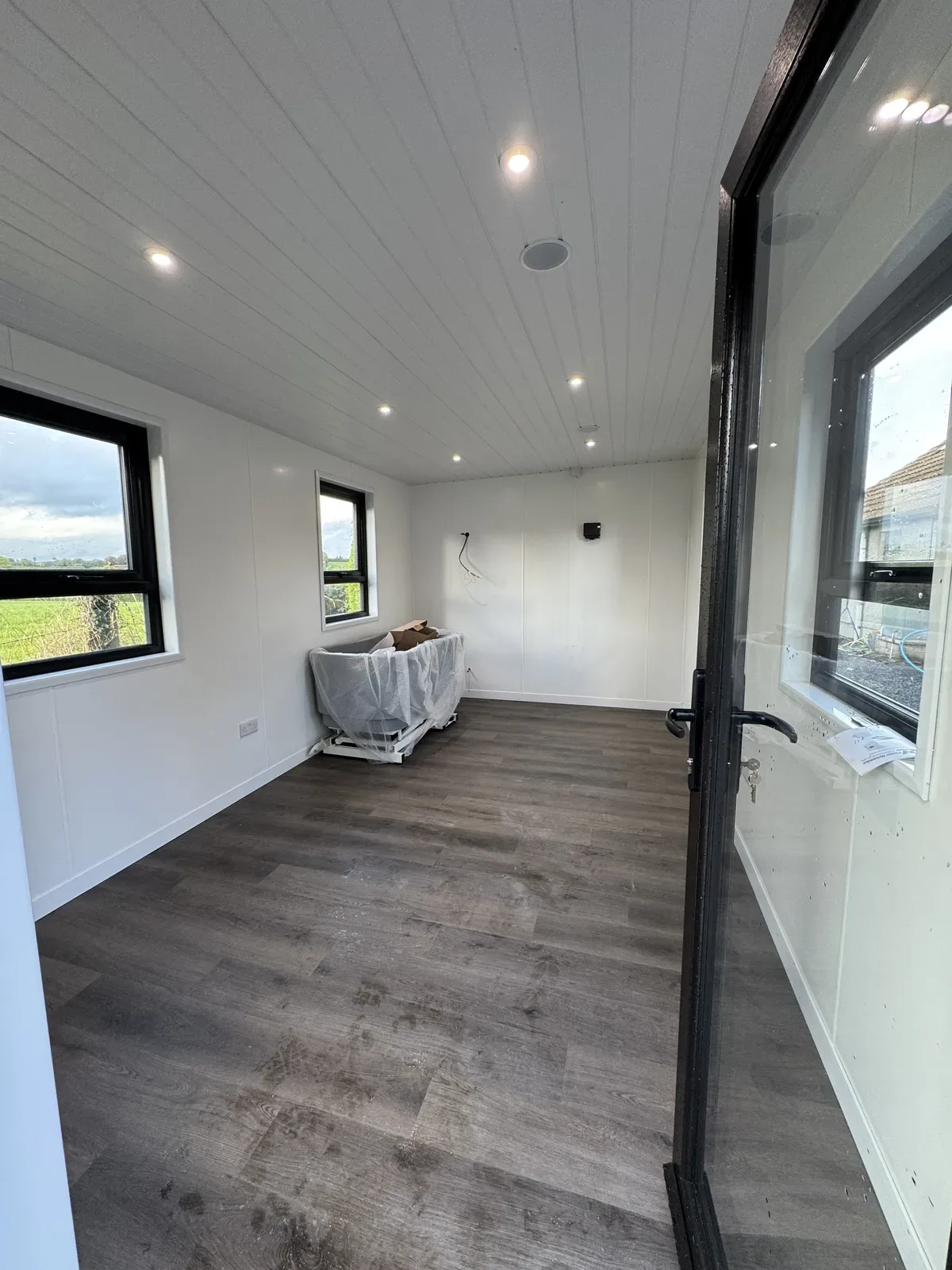 Garden room interior with clad ceiling and downlights
